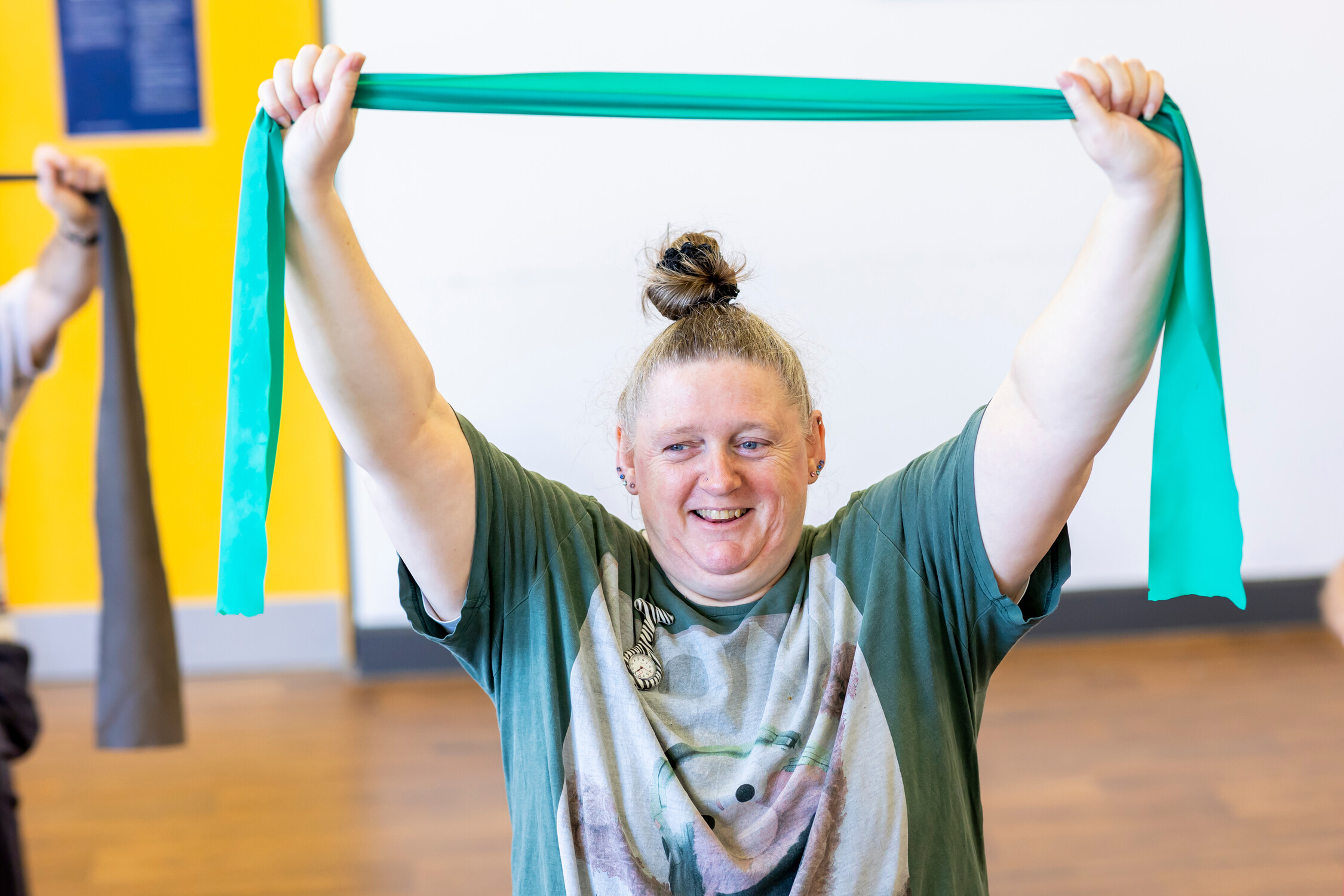 Lady holding a ribbon over her head