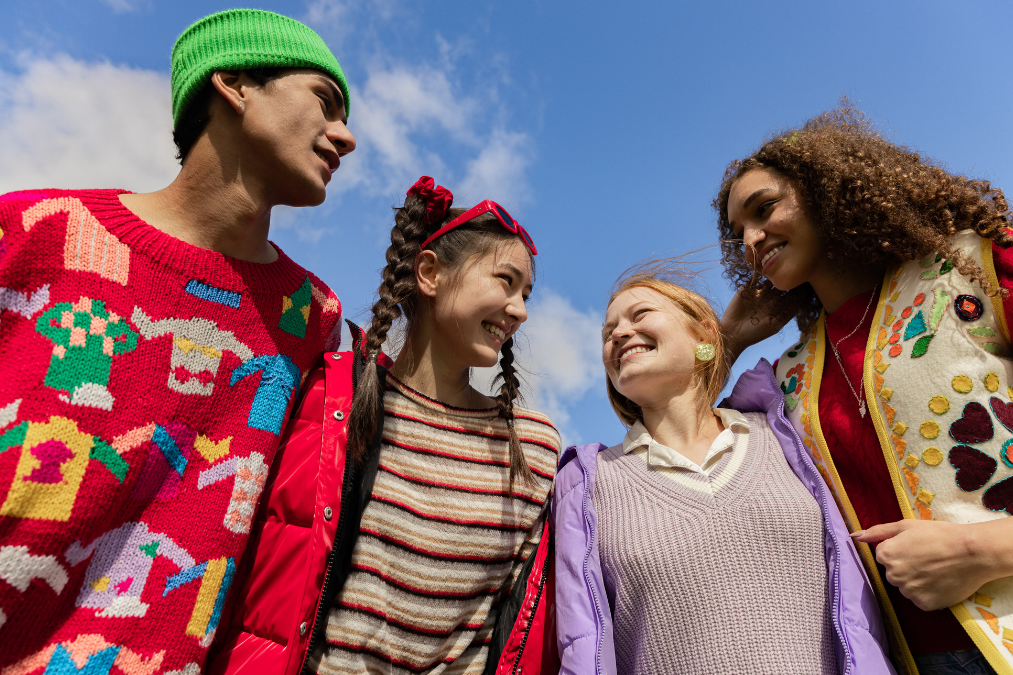 Four teenagers smiling
