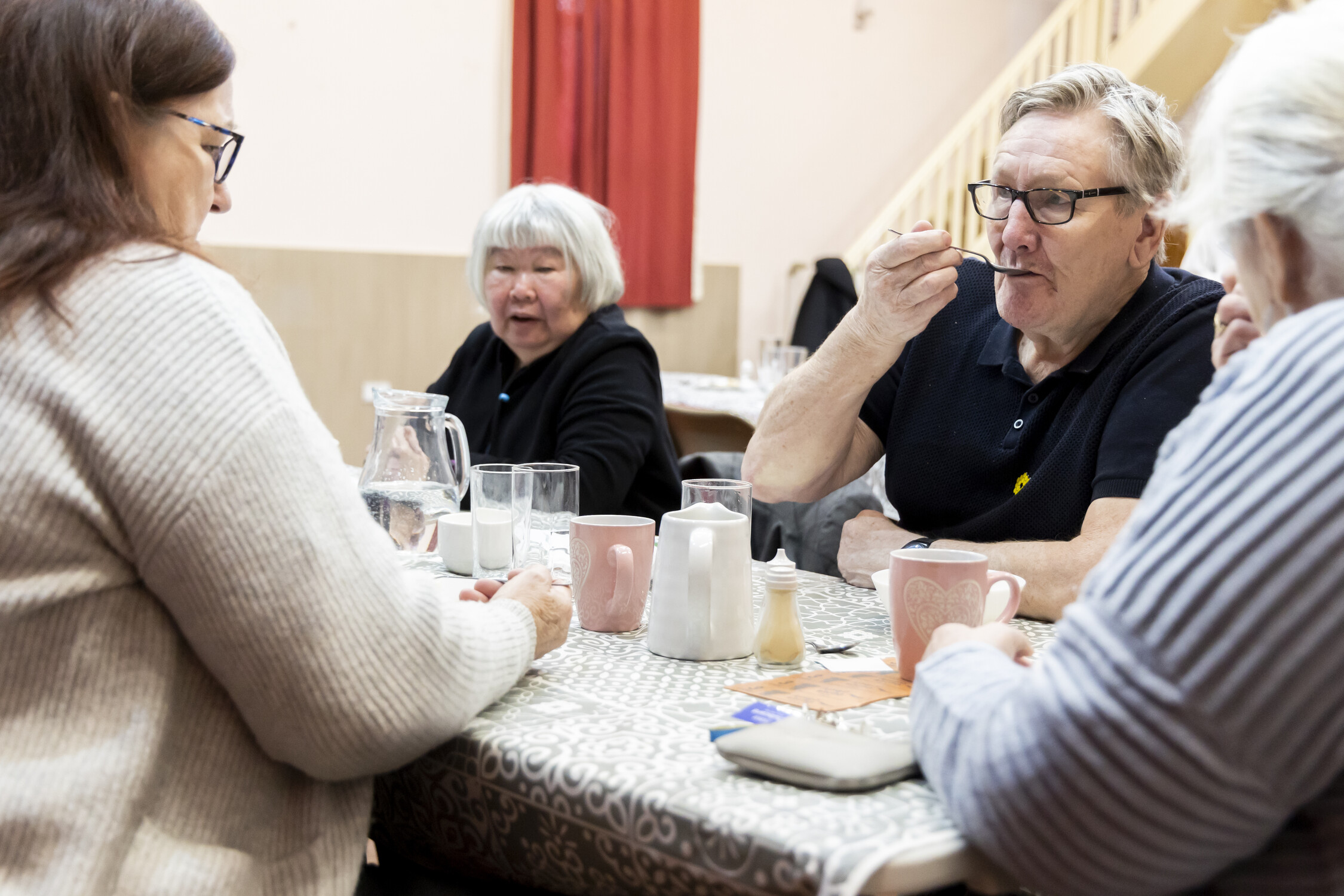 Four people eating at a table