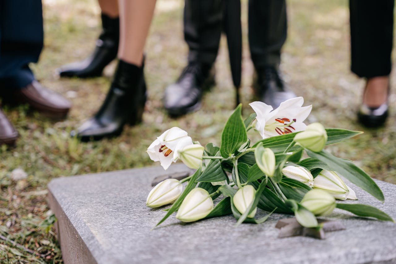 Funeral Flowers on top of a grave stone at a funeral